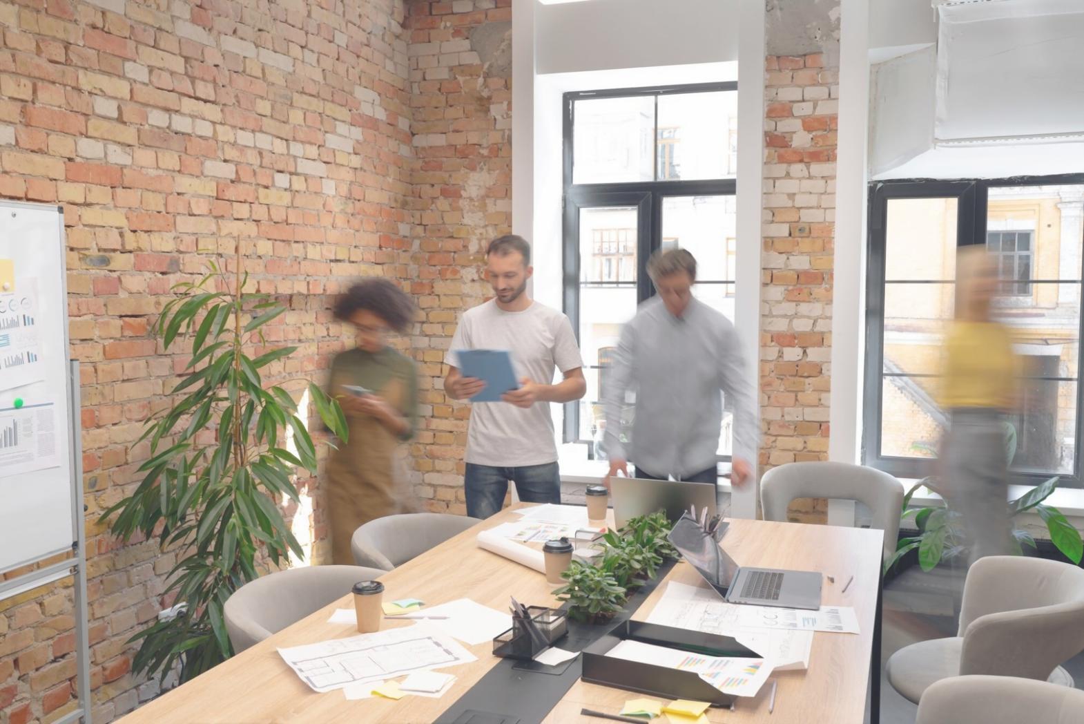 Business owner reviewing financial reports and planning documents with calculator and charts