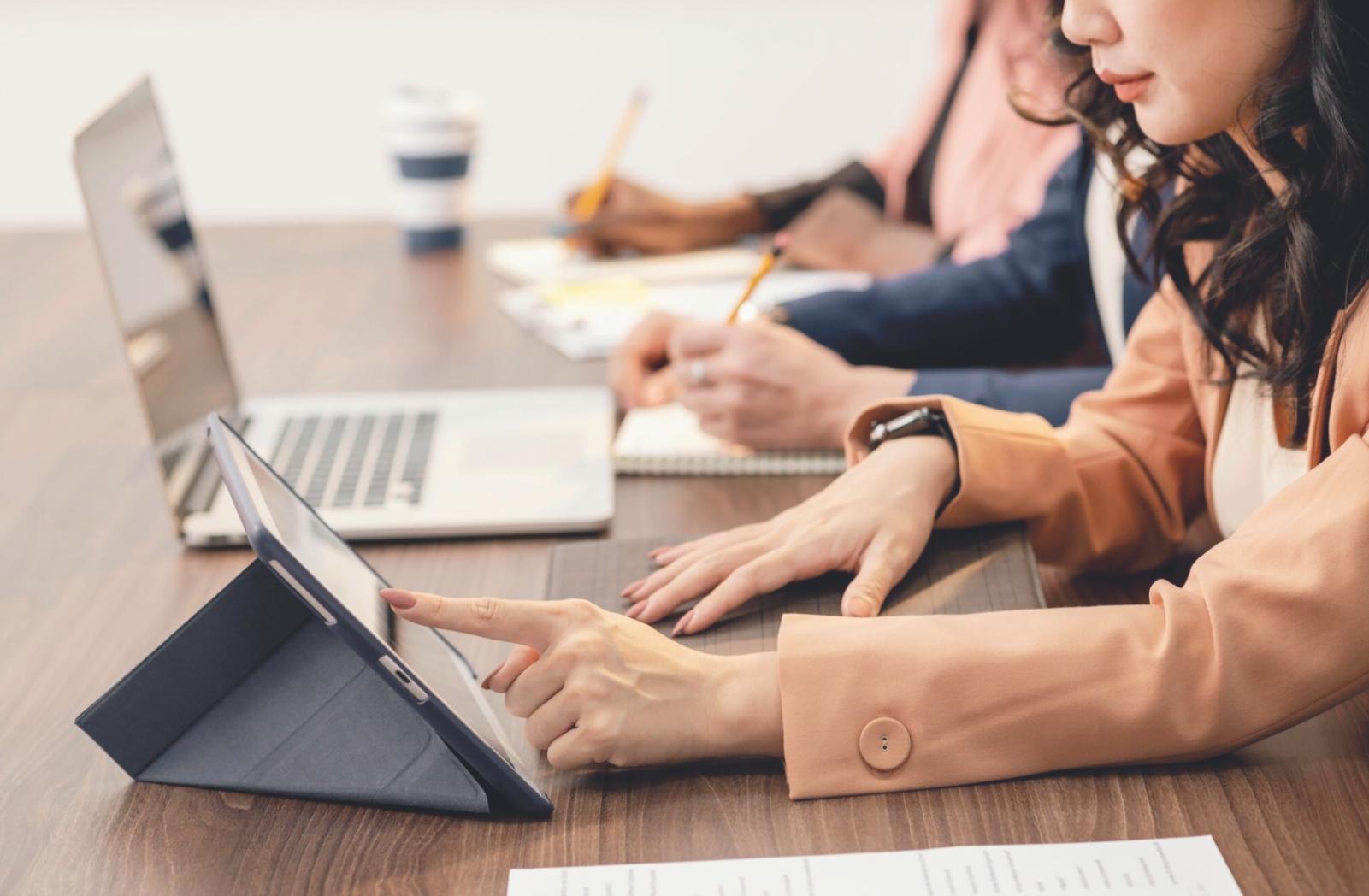 Business professionals reviewing financial documents and charts in a modern Australian office setting